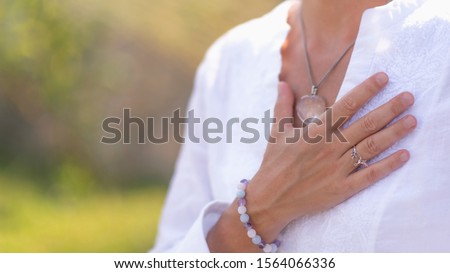 Gratefulness – Woman expressing gratitude with hands. Close up image of female hands in prayer position outdoor. Self-care practice for wellbeing Royalty-Free Stock Photo #1564066336