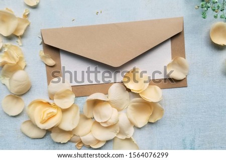 card mockup and rose petals  on blue background