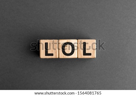 LOL - acronym from wooden blocks with letters, abbreviation LOL laugh out loud concept, gray background Royalty-Free Stock Photo #1564081765