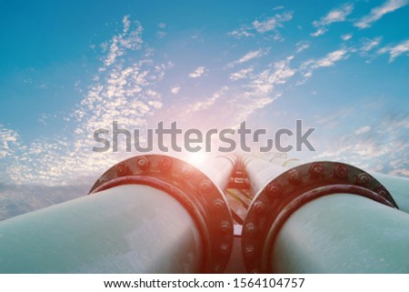close up old Slip on flange connecting with green pipe line, Tubes running in the direction of the setting blue sky, pipe line transportation is most mammon copy space. Royalty-Free Stock Photo #1564104757