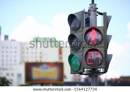 Focus on street lights with red color for pedestrian and green for transport. Set for controlling traffic at road junctions and crosswalks. Road safety concept. Blurred background
