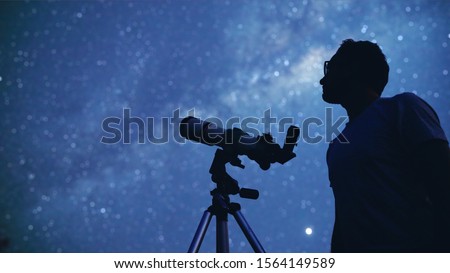 Astronomer with a telescope watching at the stars and Moon. My astronomy work. Royalty-Free Stock Photo #1564149589