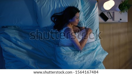 overlooking of asian woman sleep well with smile at night  Royalty-Free Stock Photo #1564167484