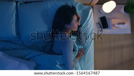 overlooking of asian woman sleep well with smile at night  Royalty-Free Stock Photo #1564167487