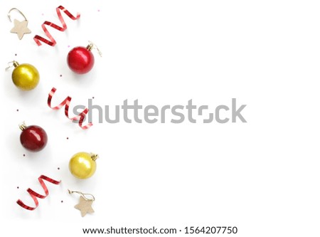 minimalistic christmas composition. White isolated background with Christmas red balls, decorations, wrapping tape spirals, star sparkles. top view, copy space, happy new year concept