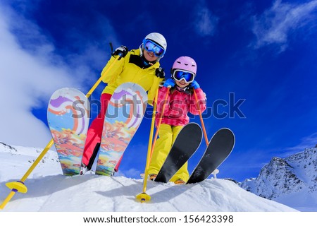 Ski, skiers, sun and winter fun - skiers enjoying ski vacation