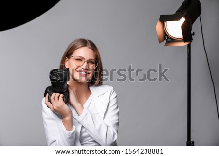 Beautiful female photographer in studio