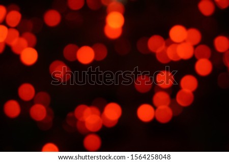 blurred background of red holiday lights bokeh effect.