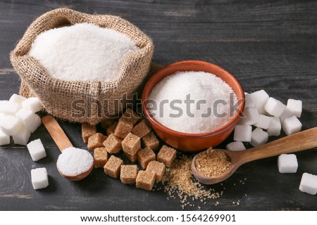 Different sugar on dark table Royalty-Free Stock Photo #1564269901