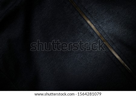 Background image Jacket. Patterns of black fabric and metal zipper. focus And a dark tone.