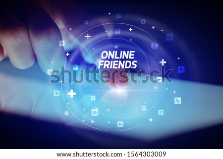 Finger touching tablet with social media icons and ONLINE FRIENDS