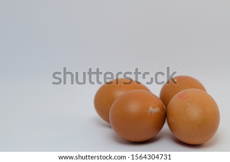 A close up picture of four eggs over the white background arranged neatly