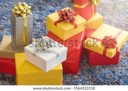 Luxury New Year gift box and Christmas gift boxed with bow ribbon in Christmas background.