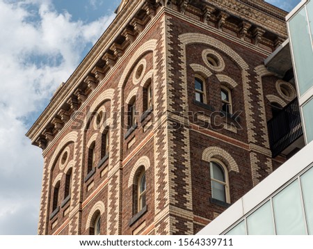 Close up on the windows arches of the Yorkshire Brewery Heritage building in Wellington Street, Collingwood, Victoria, Australia. Royalty-Free Stock Photo #1564339711