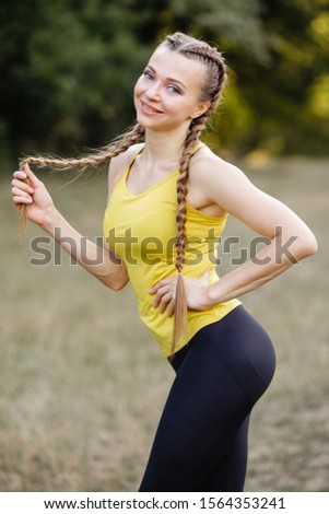 beautiful sports girl goes in for sports in the park on the nature