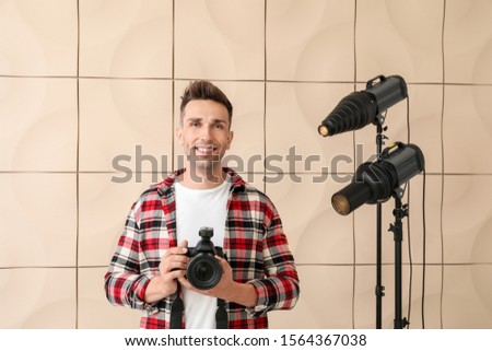 Handsome male photographer in studio