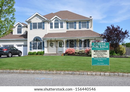 Real Estate For Sale Welcome Open House sign on suburban McMansion home in residential neighborhood USA