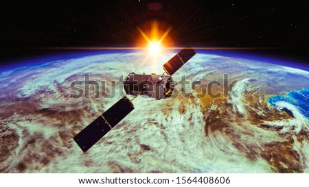 Space craft or satellite above earth. Sunrise. The elements of this image furnished by NASA.
