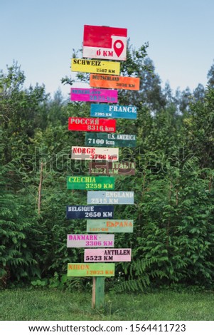 Rural tourism sign post with name of countries direction