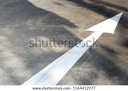 The arrow points the way across the road