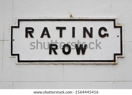 Road Sign on a wall reading "Rating Row"
