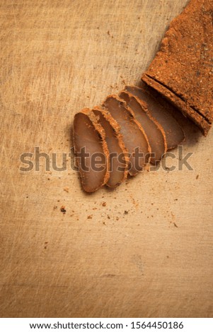 Basturma Armenian cuisine dish dry smoked horse meat food photography of wooden cutting board background vertical picture 
