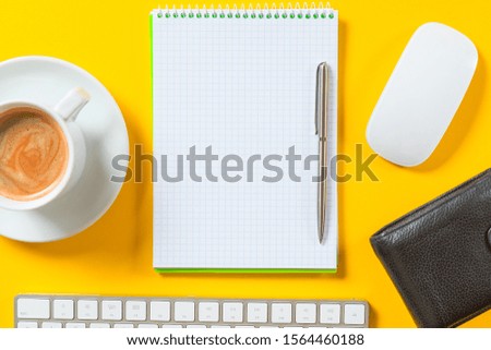 Top view of business working place with cup of coffee, Empty workspace on yellow table background.