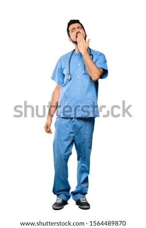 Full-length shot of Surgeon doctor man yawning and covering wide open mouth with hand over isolated white background