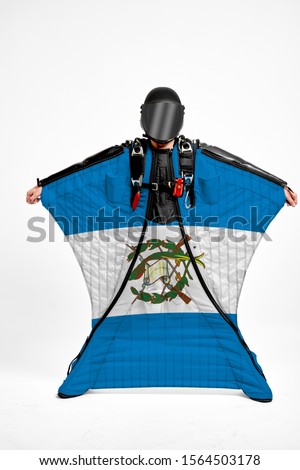 Guatemala flag travel. Bird Men in wing suit flag. Sky diving men in parashute. Patriotism, men and flag.
                               