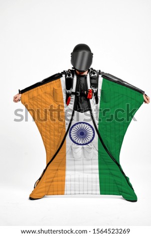 India flag travel. Bird Men in wing suit flag. Sky diving men in parashute. Patriotism, men and flag.
                               