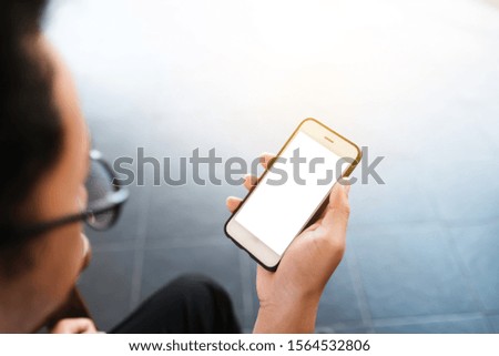 Close up of man using blank cell phone and credit card sending massages shopping online on the coffee shop.