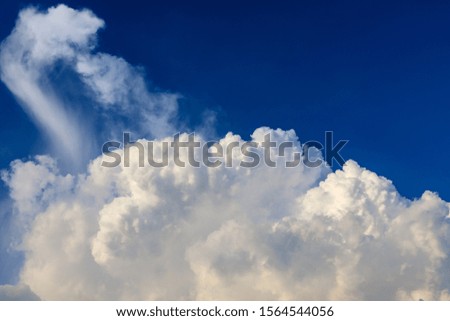 Clear blue sky with large cumulus big clouds
