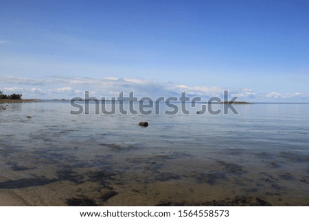 beautiful sea view with clear water under blue sky with big white clouds on summer day