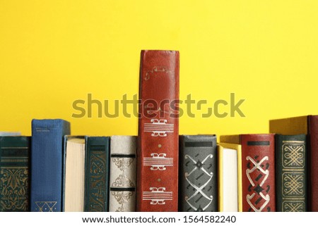Collection of old books on yellow background