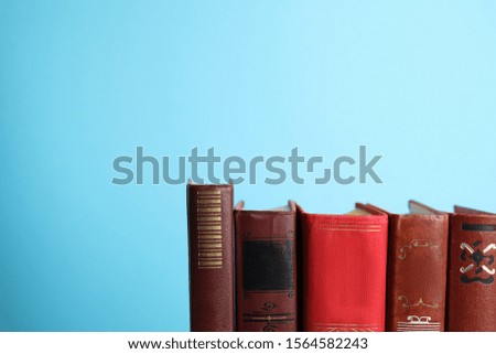 Collection of old books on light blue background