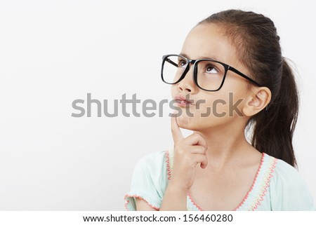Young girl in glasses, looking up