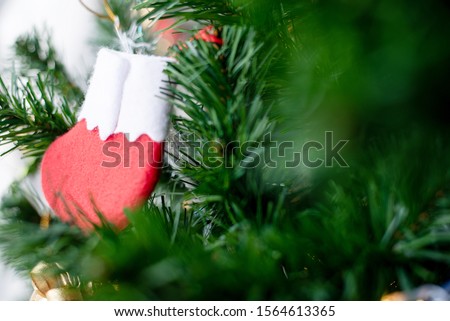 Close-up shot of red sock sign of chrstmas on the tree . Merry christmas celebration decoration concept.
