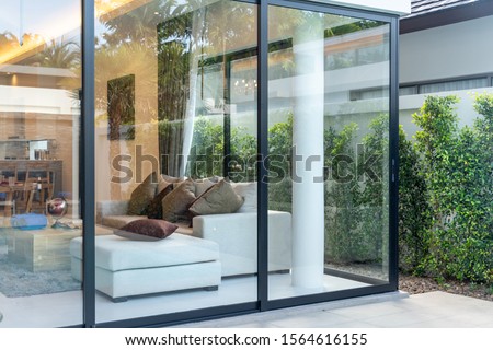 open plan living area with sliding door and garden Royalty-Free Stock Photo #1564616155