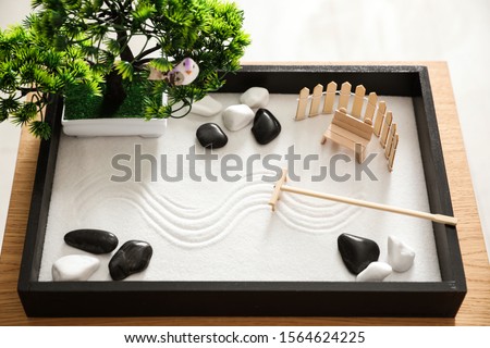 Beautiful miniature zen garden on wooden table