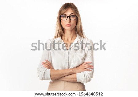 Strict Lady Boss. Serious Businesswoman Standing Crossing Hands Looking At Camera On White Studio Background. Isolated
