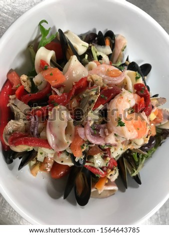 Chilled seafood salad , clams, shrimp , mussels
