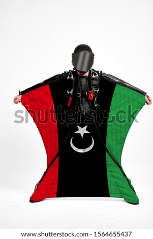 Libya flag travel. Bird Men in wing suit flag. Sky diving men in parashute. Patriotism, men and flag.
                               