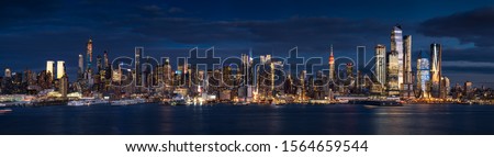 New York City (Manhattan) panoramic view at dusk from the Hudson River. The view includes the skyscrapers of Midtown West (Hudson Yards redevelopment project). NYC, NY, USA Royalty-Free Stock Photo #1564659544