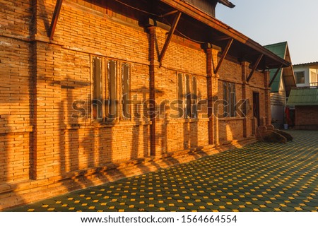 Red bricks wall under the sunlight with shadow on it