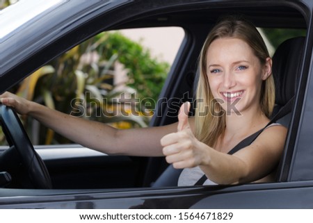 female driver showing ok sign