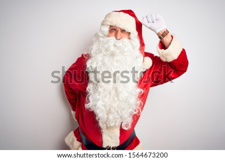 Middle age handsome man wearing Santa costume standing over isolated white background Dancing happy and cheerful, smiling moving casual and confident listening to music