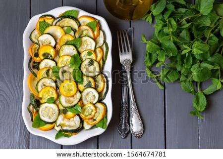 Zucchini alla Scapece.  Zucchini and summer squash marinated  in  olive oil with garlic  and mint. Italian cuisine. Royalty-Free Stock Photo #1564674781