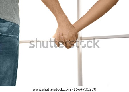 Young people holding hands indoors, closeup. Happy family
