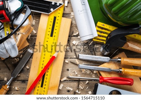 Top view of carpenter's tools on a wooden work table. Construction industry, do it yourself. Wooden work table.
