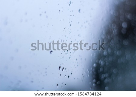 Rain Water droplets  on glass mirror abstract background.